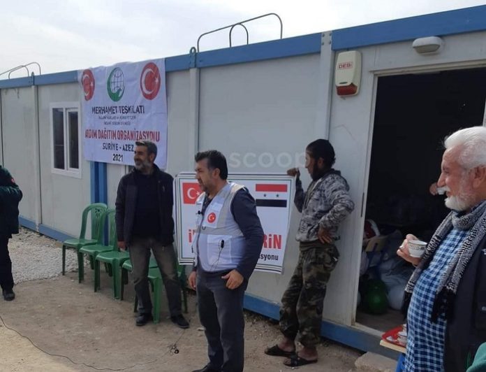 علم الأسد يظهر أثناء توزيع إغاثة شمال حلب ومسؤول تركي يوضح